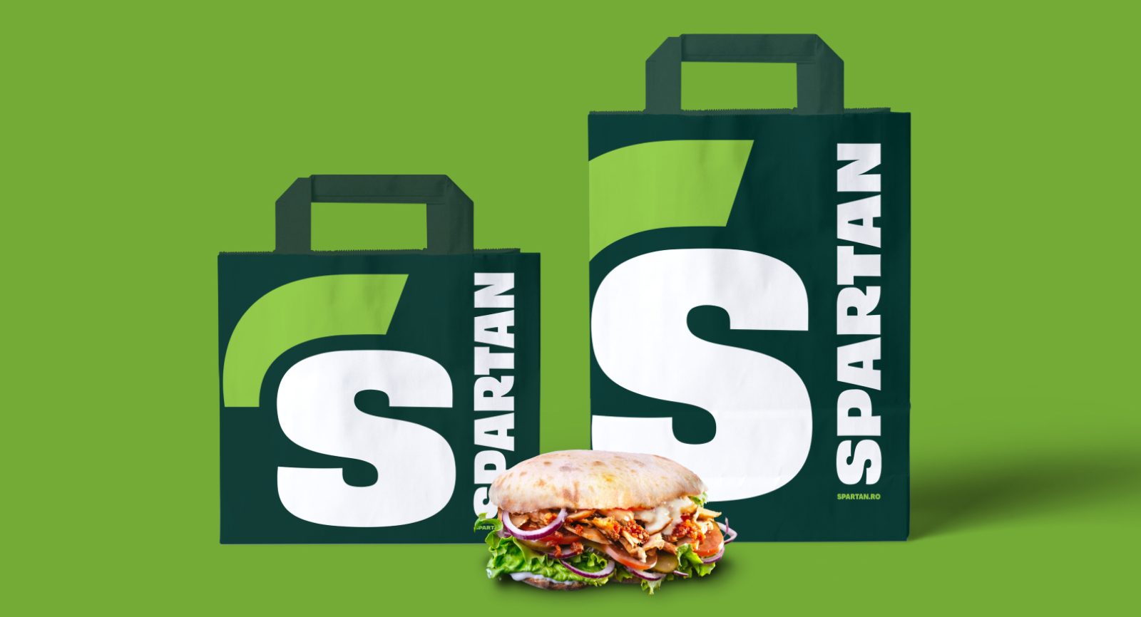 Takeaway packaging featuring modern Spartan logo and colors.