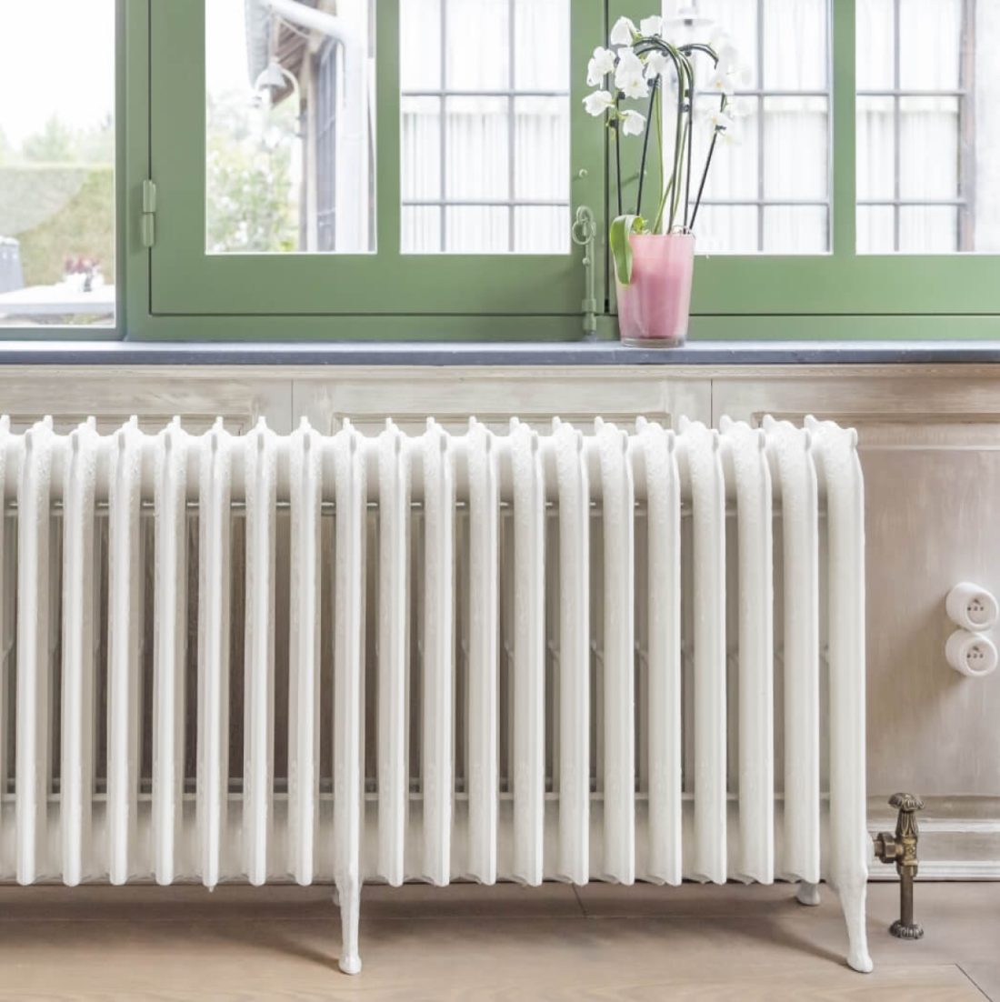 Lifestyle photo of vintage radiator in a home setting.
